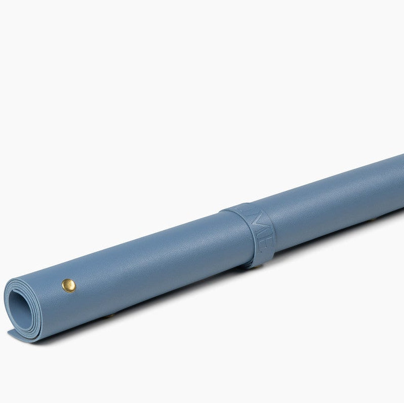 Blue leather potting mat rolled up on white background