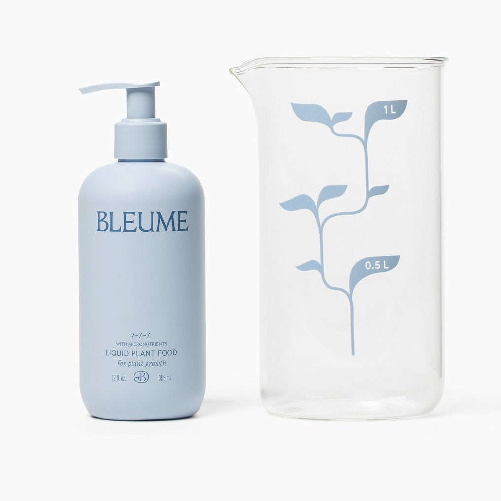 Bleume houseplant fertilizer and bleume measuring beaker on white background
